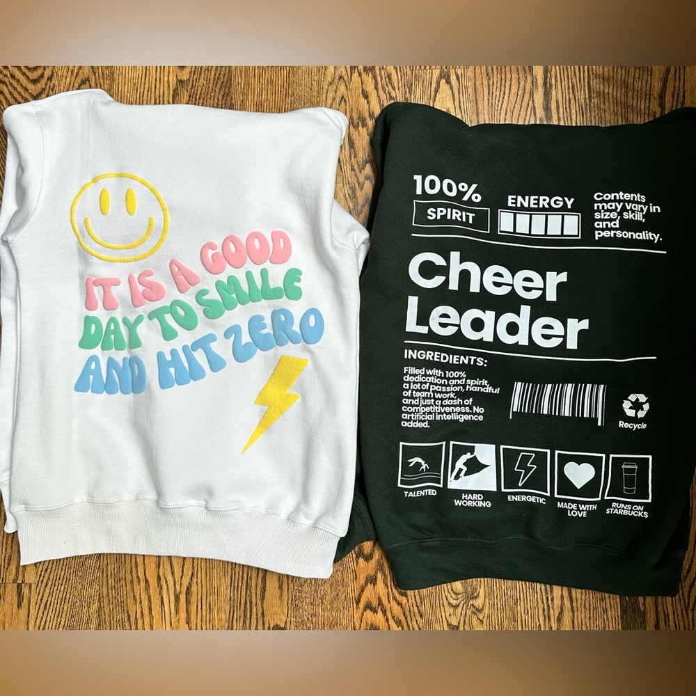 Two oversized adult small cheerleader hoodies for sale.